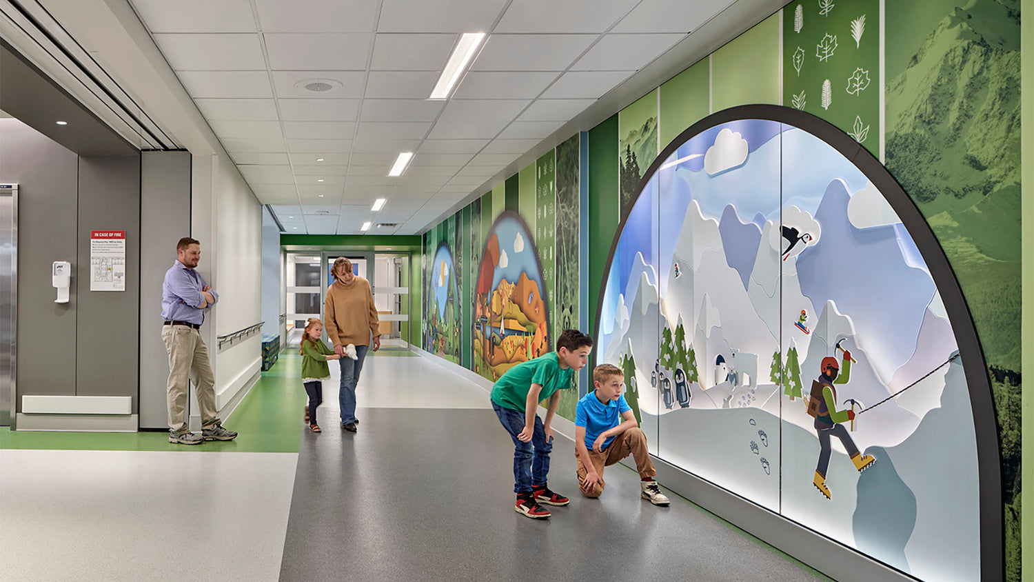 Children and families at Boston Children's Hospital exploring an interactive wall. Mochee Memos proudly donates a portion of sales to support life-changing care.